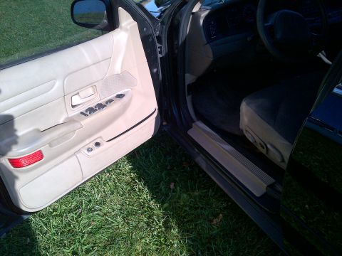 2001 Ford Crown Victoria - Interior view of a 2001 Ford Crown Victoria, focusing on the driver's side door panel and seat.