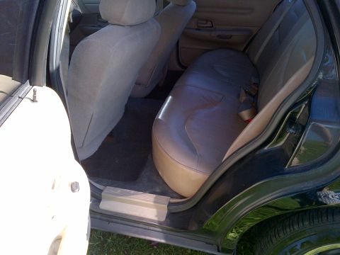2001 Ford Crown Victoria - The rear interior of a 2001 Ford Crown Victoria shows fabric and leather seats with seatbelts.