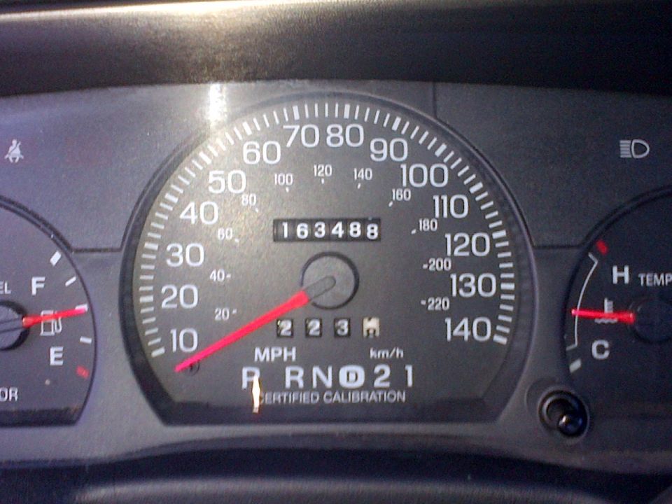Dashboard gauges showing 163,488 miles, MPH, and RPMs