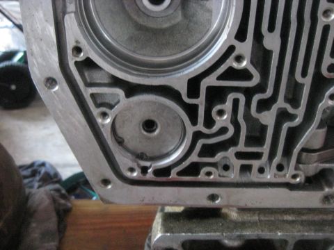1994 Ford Bronco - Close-up view of a transmission valve body, showing its complex internal passageways.