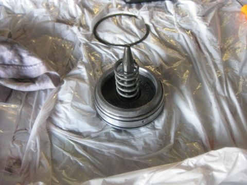 1994 Ford Bronco - Close-up of a disassembled automotive component, a spring and seal mechanism.