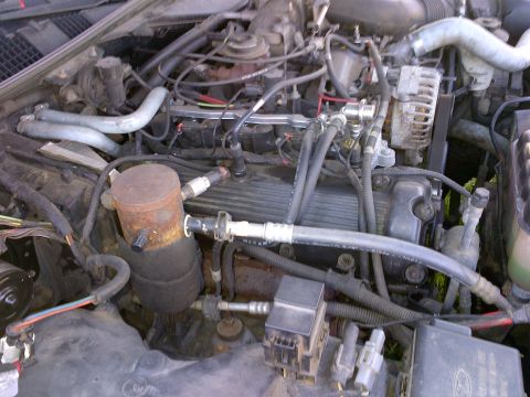2001 Ford Crown Victoria - Close-up view of a vehicle's engine bay, showing intricate mechanical parts and wiring.