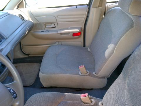 2001 Ford Crown Victoria - Interior view of a 2001 Ford Crown Victoria, highlighting the tan upholstery and dashboard details.