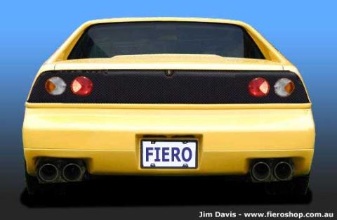1994 Ford Crown Victoria - This yellow sports car features a distinctive rear end with dual exhaust pipes and a 'FIERO' license plate, suggesting it is a Pontiac Fier…