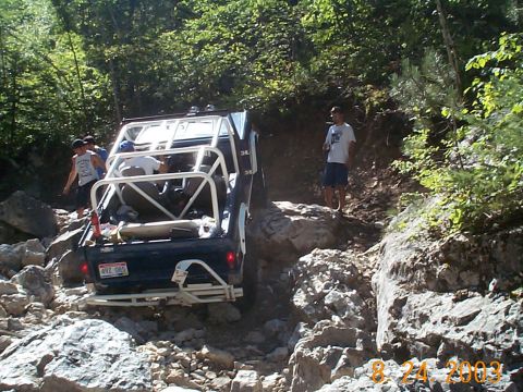 1977 Ford Bronco - This 1977 Ford Bronco is tackling a challenging off-road course with its occupants.