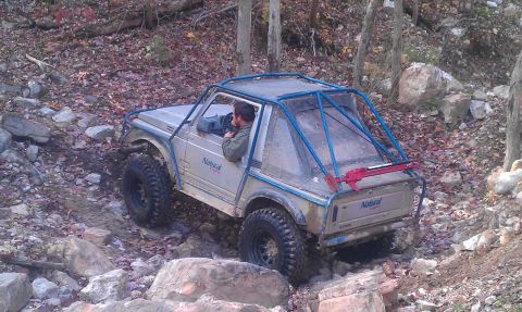 1987 Ford Bronco - Off-road vehicle navigating a challenging rocky trail during an outdoor excursion.