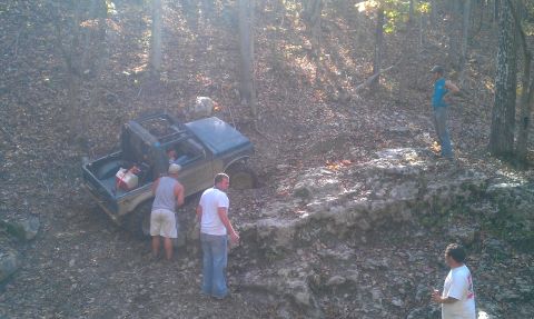 1987 Ford Bronco - Off-roading adventure in the woods with a 1987 Ford Bronco encountering difficult terrain.