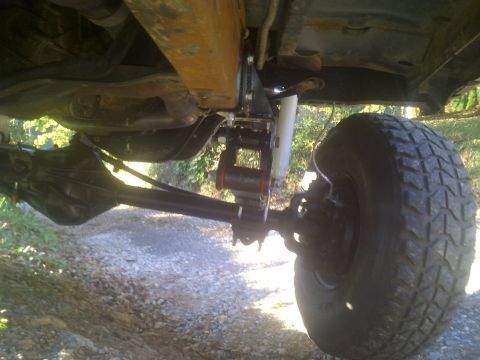 1995 Ford Bronco - Modified undercarriage of a 1995 Ford Bronco, showing suspension and large off-road tires.