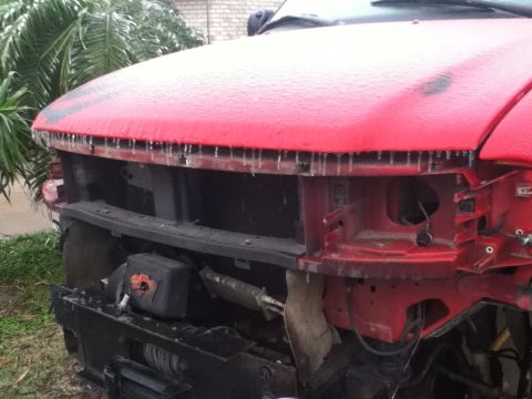 1990 Ford Bronco - Red vehicle front end showing damage and ice accumulation.