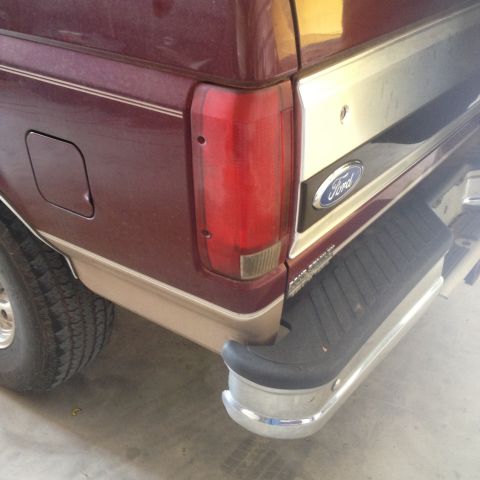 1996 Ford Bronco - Close-up of the rear of a 1996 Ford Bronco, showing the taillight and bumper detail.