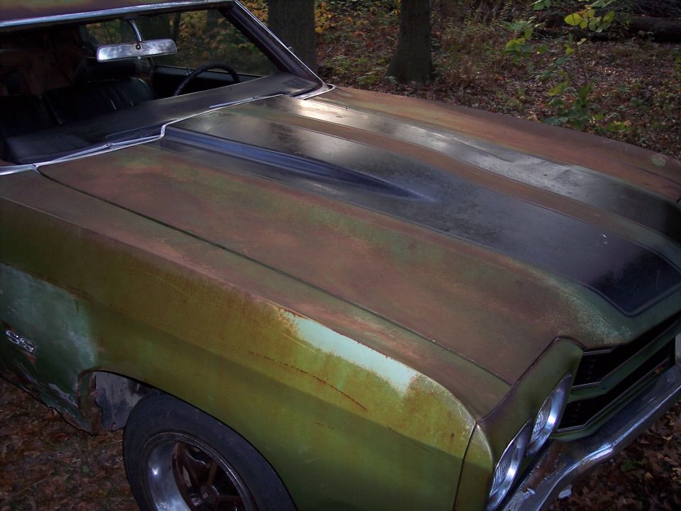 Green 1970 Chevrolet Chevelle SS with rust and a black hood stripe