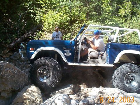 1977 Ford Bronco - Blue 1977 Ford Bronco tackling a difficult off-road trail.