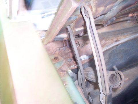 1970 Chevrolet Chevelle - Close-up view of corroded hood latch components within a vehicle's engine bay.