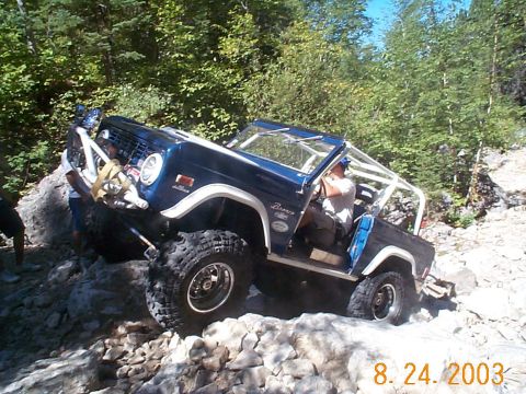 1977 Ford Bronco - This 1977 Ford Bronco is navigating a rocky off-road path with a driver at the wheel.