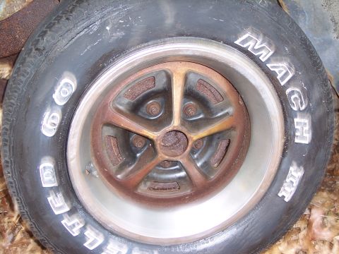 1970 Chevrolet Chevelle - A close-up shows a rusty wheel with raised white lettering on the tire.