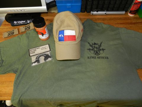 1996 Ford Bronco - A collection of items including a cap, t-shirt, seasoning, and a tool are laid out on a table.