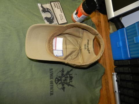 1996 Ford Bronco - Interior of a tan baseball cap and a green t-shirt with a graphic are displayed on a table.