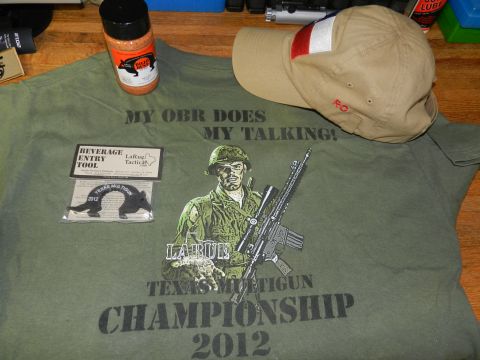 1996 Ford Bronco - A collection of items including a t-shirt, seasoning, cap, and a beverage tool are laid out on a wooden surface.