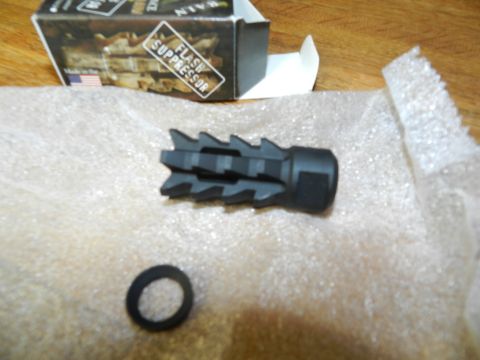 1996 Ford Bronco - A flash suppressor and a washer are laid out on bubble wrap next to an open box.