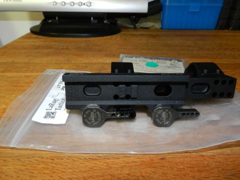 1996 Ford Bronco - LaRue Tactical scope mount shown on a wooden surface with packaging.