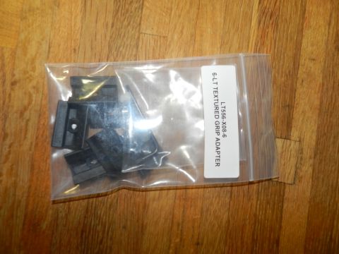1996 Ford Bronco - A bag of black plastic grip adapters is shown on a wooden surface.