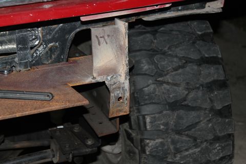 1990 Ford Bronco - Custom bumper bracket installation shown next to a large off-road tire.