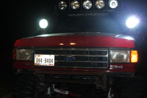1990 Ford Bronco - Front view of a red 1990 Ford Bronco equipped with a light bar and auxiliary lights.