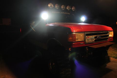 1990 Ford Bronco - Red 1990 Ford Bronco equipped with multiple auxiliary lights for off-road use.