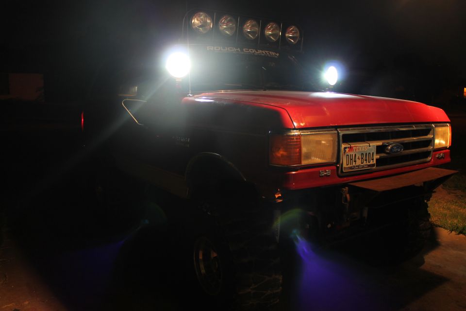 1990 Ford Bronco with roof-mounted light bar and front bumper lights
