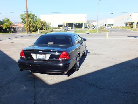 2003 Ford Crown Victoria - Straight rear shot of the black Crown Victoria showing Ford oval, dual tips and CA plate.