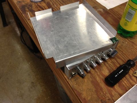 1979 Ford Bronco - A CB radio sits on a workbench next to a screwdriver and a bottle of soda.