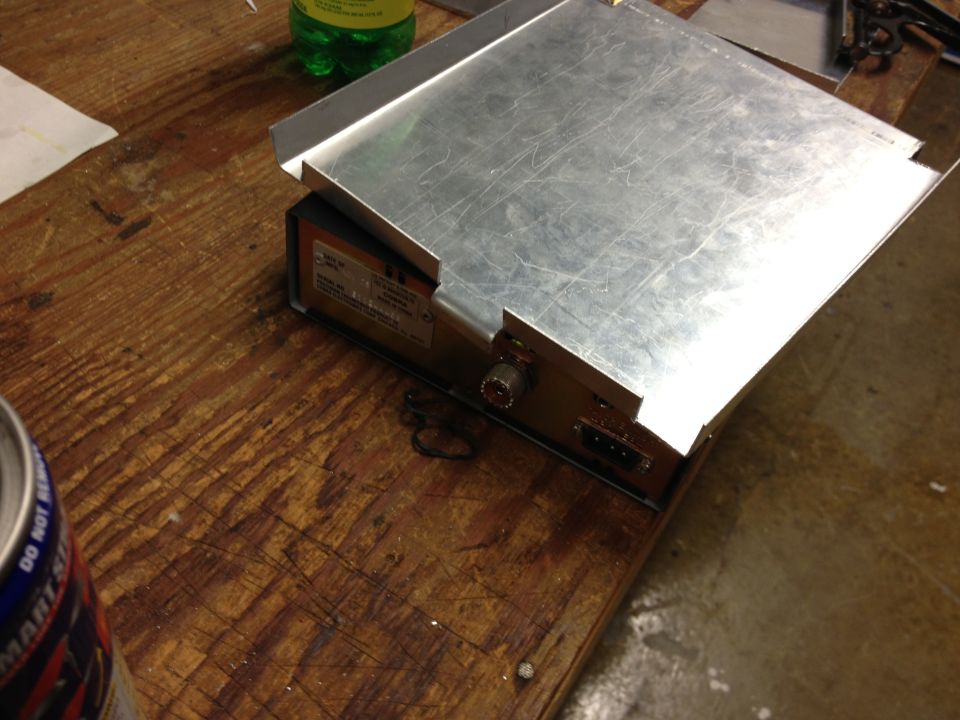 Electronic device with metal casing and connectors on a wooden surface