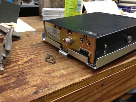 1979 Ford Bronco - A CB radio is shown on a workbench with various tools and supplies in the background.