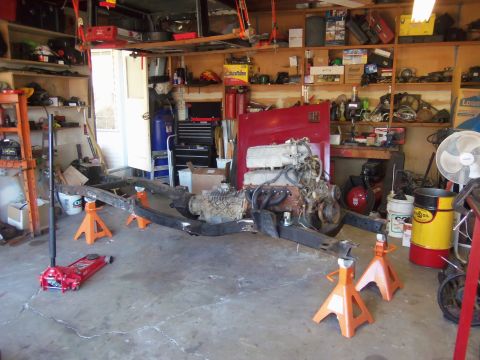 1968 Ford Bronco - Vehicle frame and powertrain components are assembled in a garage setting.
