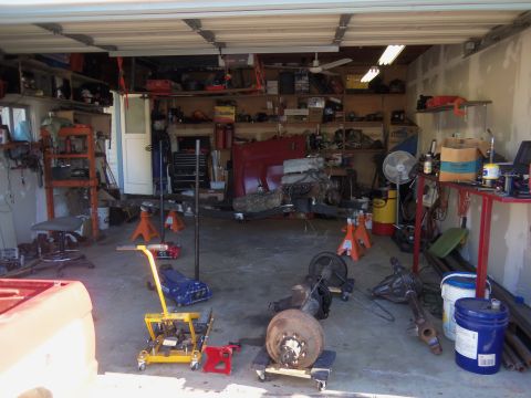 1968 Ford Bronco - A garage filled with automotive parts and tools, suggesting a project in progress.