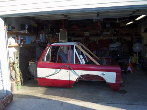 1968 Ford Bronco - 1968 Ford Bronco body undergoing modifications in a garage setting.