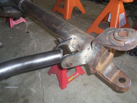 1968 Ford Bronco - This fabricated suspension part is supported by jack stands in a workshop setting.