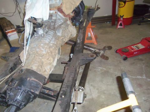 1968 Ford Bronco - Vehicle frame and powertrain components are laid out in a workshop setting, possibly for repair or modification.