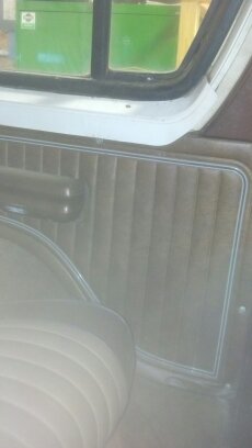 1978 Ford Bronco - Close-up of a vehicle's interior door panel, showing upholstery and trim details.