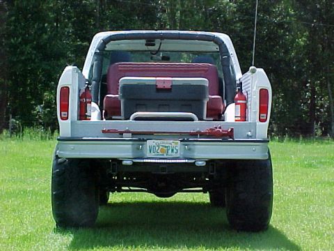 1978 Ford Bronco - Rear view of a 1978 Ford Bronco with a toolbox and fire extinguishers in the cargo area.