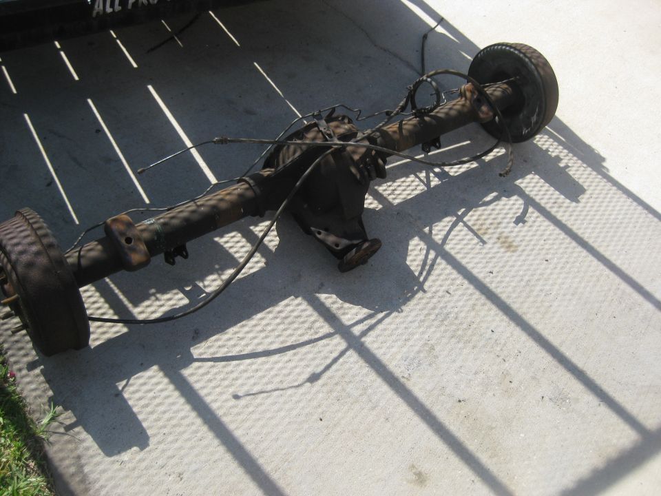 Rear axle assembly with drum brakes and suspension components