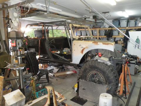 1961 International Scout 800 - A 1961 International Scout 800 is seen in a garage, stripped down and fitted with a custom roll cage.