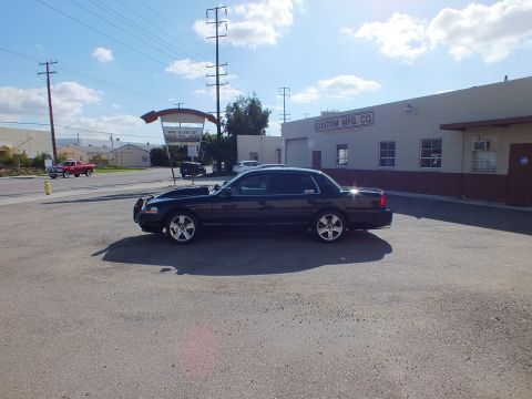 2003 Ford Crown Victoria - Full left-side profile of the lowered black Crown Victoria near Custom Mfg. Co.