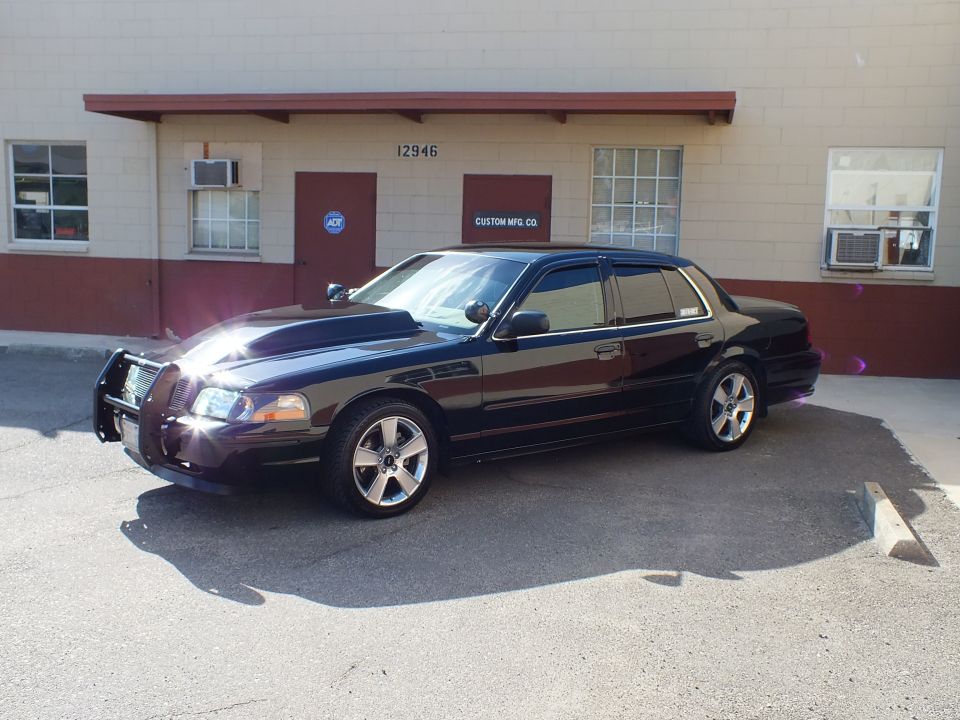 Black Mercury Marauder front three-quarter with chrome brush guard and chrome wheels, 12946 Custom Mfg Co