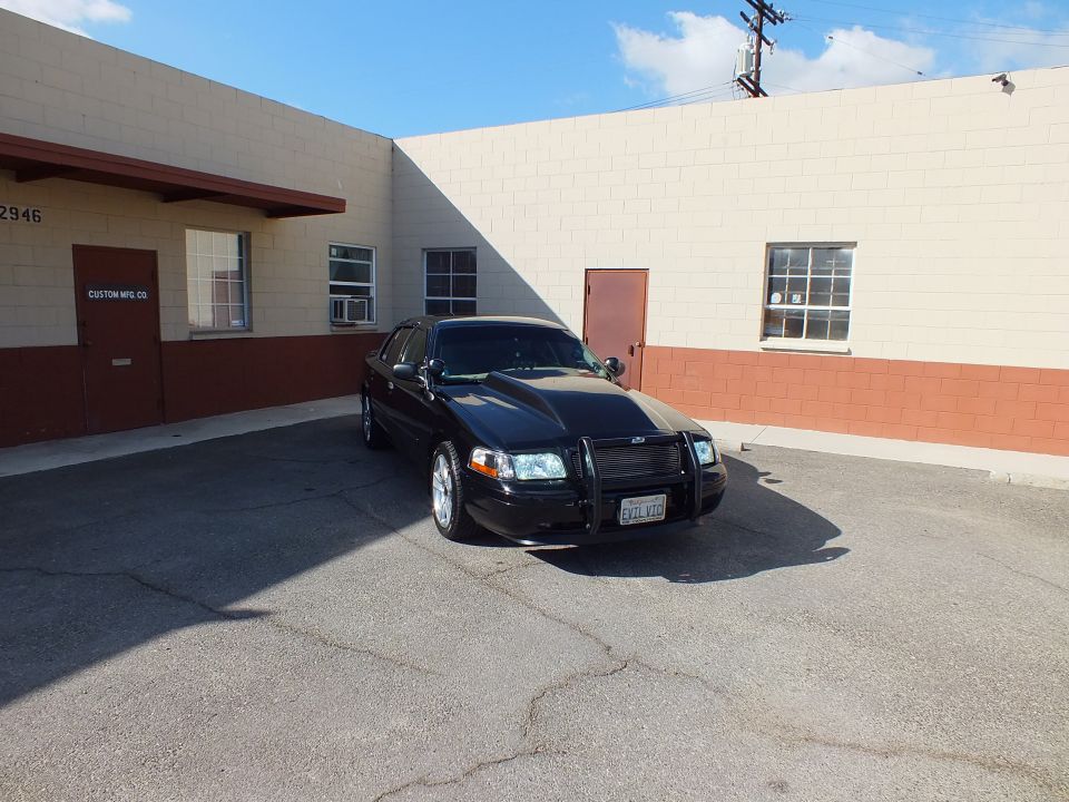 Black Mercury Marauder front three-quarter with chrome push bar and EVIL VIC plate, sunlit hood