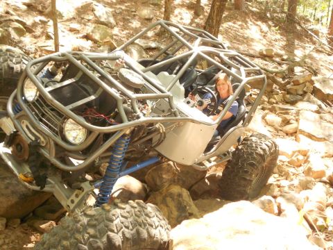 1967 Ford Mustang - A custom-built buggy navigates a challenging rocky trail with a driver at the wheel.