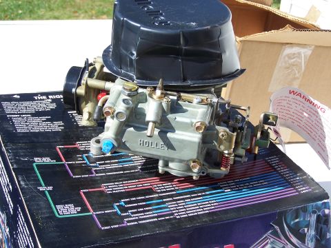 1991 Ford LTD Crown Victoria - A Holley carburetor is shown resting on a diagram detailing wiring and application information.