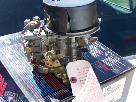 1991 Ford LTD Crown Victoria - Holley carburetor and associated parts, including instructions and air cleaner, are laid out.