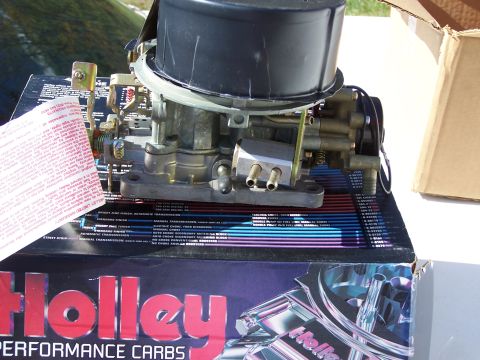 1991 Ford LTD Crown Victoria - A Holley carburetor sits on its product box, accompanied by a warranty information card.