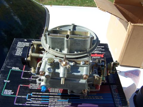 1991 Ford LTD Crown Victoria - A Holley carburetor is displayed on top of a diagram box detailing engine specifications.